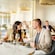 A man and a woman smiling at each other while sitting at a table in a restaurant